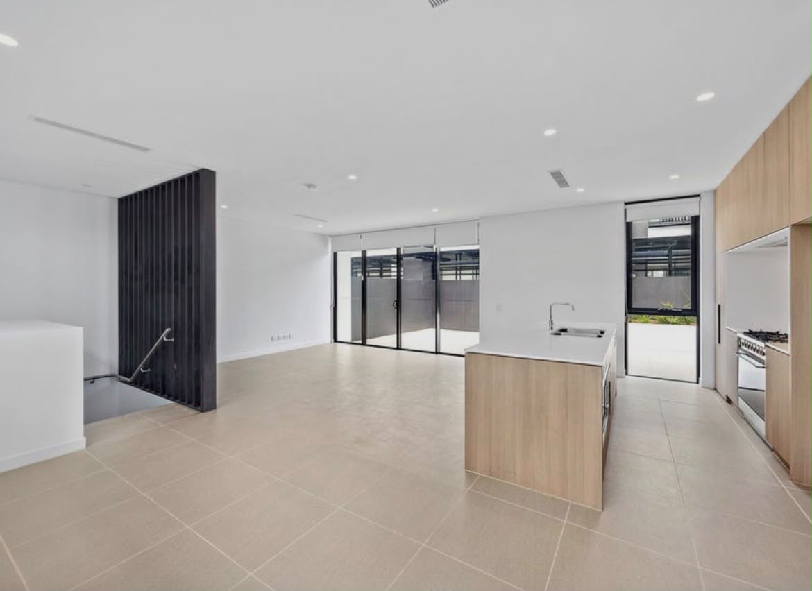 Large-format tiles across an open-plan apartment